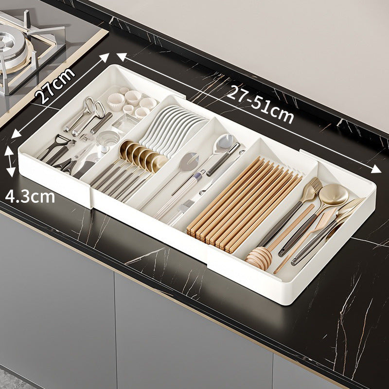 Nexora Plus expandable kitchen drawer organizer tray fully loaded with cutlery on a marble counter, showing 27cm to 51cm width and 4.3cm height